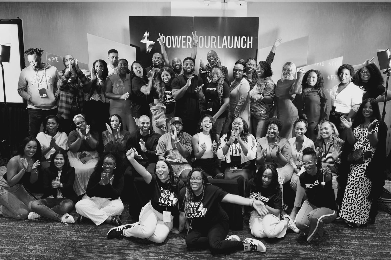 A room full of Power Your Launch founders gathered together at an in-person event