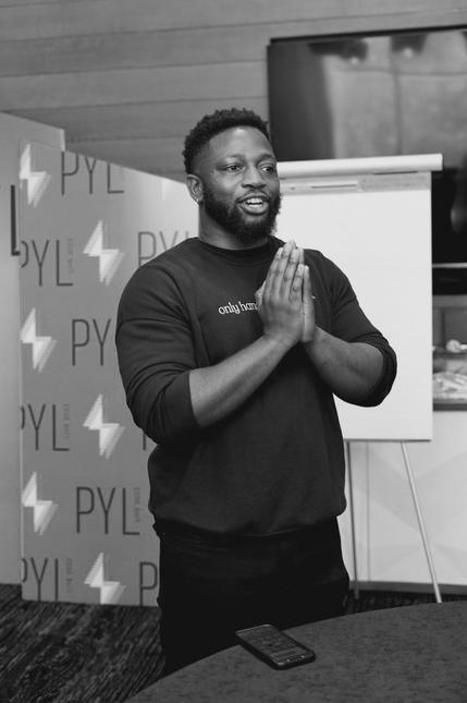 Abu Fofanah in front of a Power Your Launch backdrop